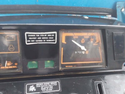 Ford 2120 tractor dashboard with fuel gauge and engine warning light.