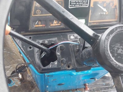 Interior dashboard of a blue Ford 2120 tractor with visible controls and gauges.
