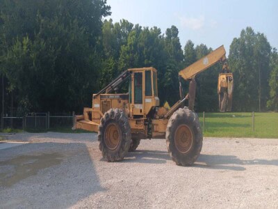 John Deere 748 wheel loader with front bucket and rear excavator arm, yellow and black, on gravel surface.
