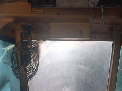 Inside view of a John Deere 748 tractor cab with visible controls and windshield.