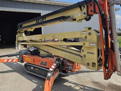 2015 JLG X700AJ boom lift with extended arm and basket, outdoor setting, ready for construction work.