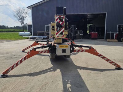 2015 JLG X700AJ telescopic boom lift with extended outriggers on concrete surface.