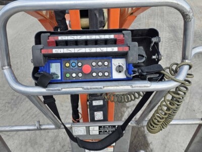 Control panel of a 2015 JLG X700AJ boom lift with joystick and control buttons.