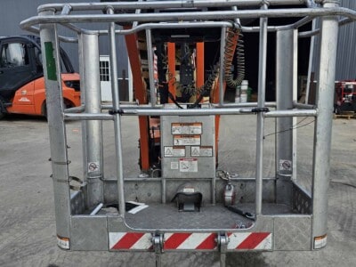 Aerial work platform basket with safety rails and control panel for JLG X700AJ.