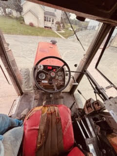 3 View from inside a Massey Ferguson 2745 tractor cab showing steering wheel and dashboard.