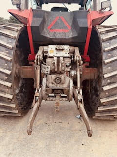 6 Front view of a Massey Ferguson 2745 tractor with visible hydraulic system and large tires.