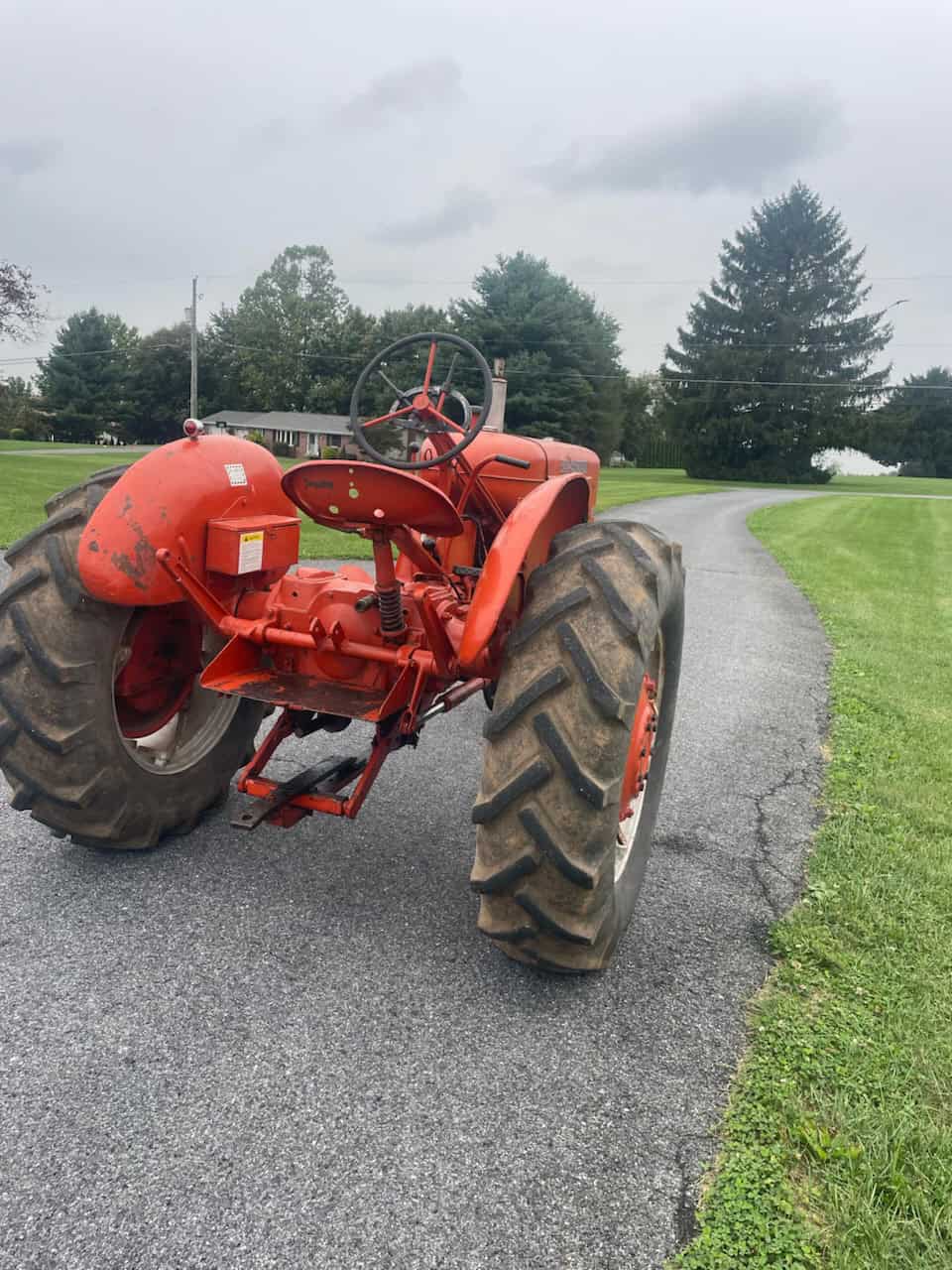 Allis-Chalmers WD Tractor in Field Allis-Chalmers WD vintage tractor with large rear tires on a rural road.