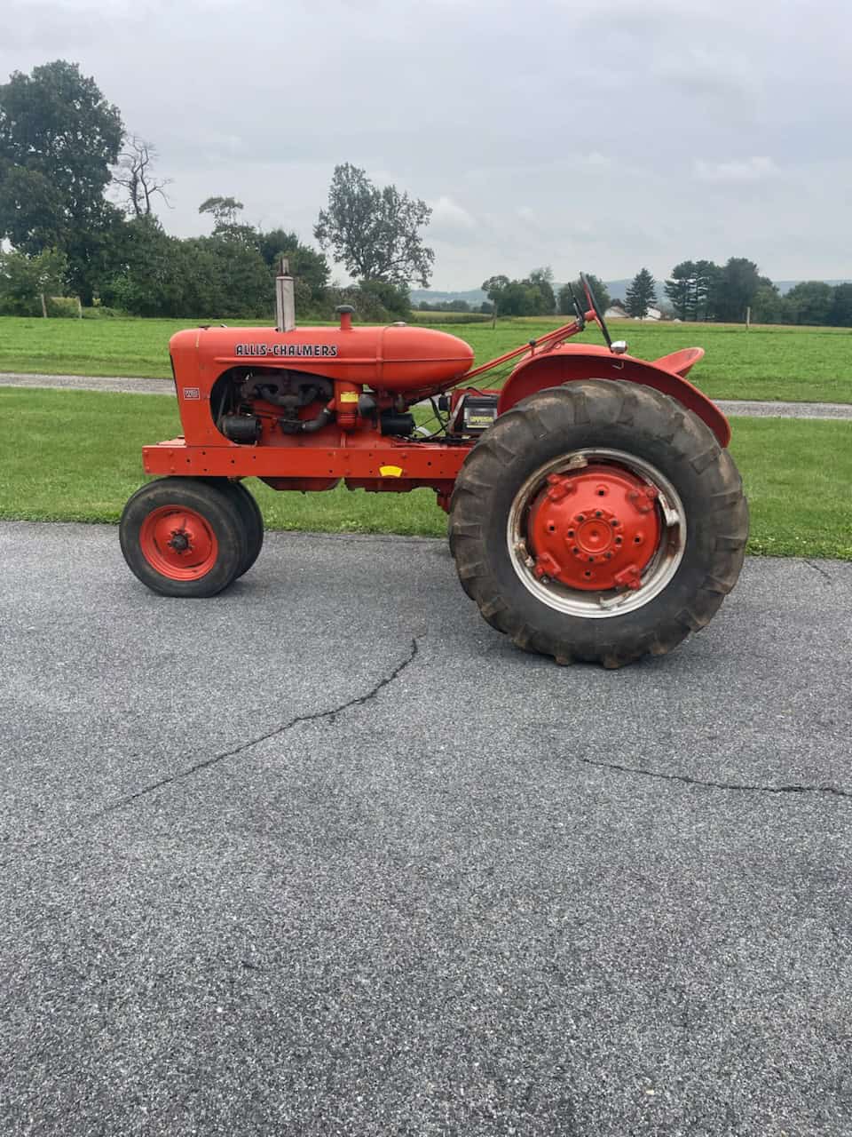 Allis-Chalmers WD tractor in red Red Allis-Chalmers WD tractor with large rear tires and open cab.