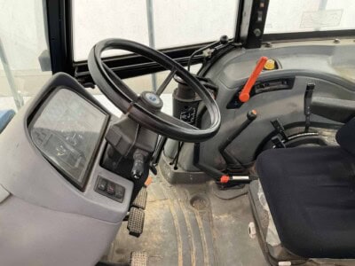 John Deere 2020 tractor cabin interior with steering wheel and controls.