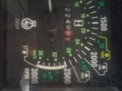 Heavy equipment dashboard with speedometer, fuel gauge, and warning lights.