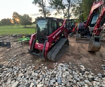 2024 YANMAR TL100VS compact track loader with enclosed cab and rubber tracks on construction site.