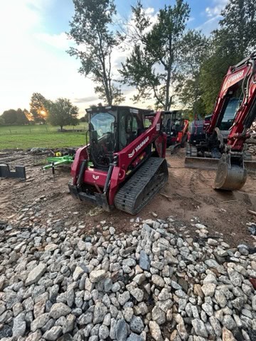 2024 YANMAR TL100VS compact track loader with enclosed cab and rubber tracks on construction site.