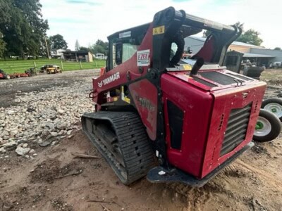 Yanmar TL100VS compact track loader with cab and rubber tracks on construction site.