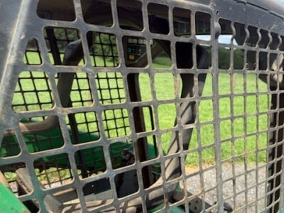 Close-up of the BOBCAT T190's protective grille and operator cabin with visible controls inside.