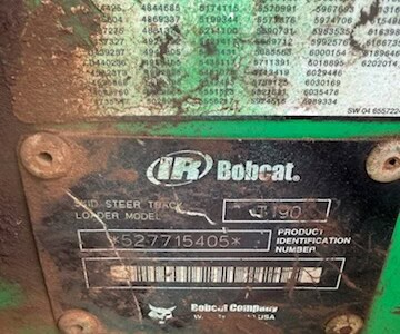 2005 Bobcat T190 compact track loader with cab and tracks, showing wear and dirt.