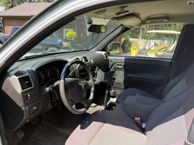 2012 Chevrolet Colorado cab interior with dashboard and seats.