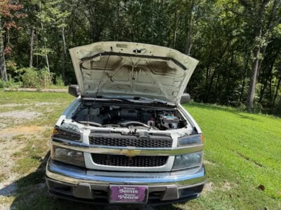 2012 Chevrolet Colorado engine with open hood showing engine components.