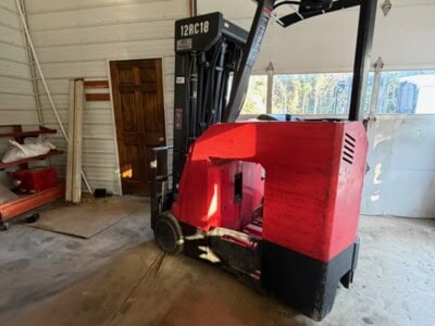 Toyota 8FBE25 electric forklift with red and black body, in a warehouse setting.