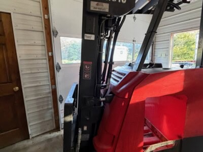 Toyota 8-Series electric forklift 12RC18 with mast and forks in warehouse.