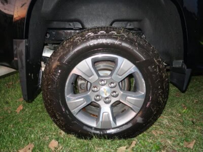 Close-up of 2018 Chevrolet Colorado Z71 alloy wheel and tire on grass.