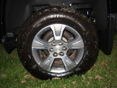 2018 Chevrolet Colorado Z71 alloy wheel with tire on grassy ground.