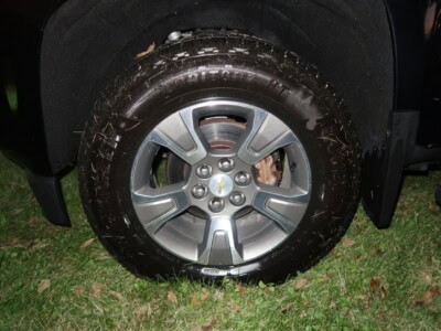 2018 Chevrolet Colorado Z71 alloy wheel with tire on grassy surface.