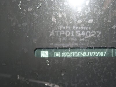 Close-up of vehicle VIN plate on 2018 Chevrolet Colorado Z71 with dirt and grime.
