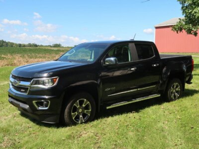 2018 Chevrolet Colorado Z71 pickup truck with black exterior and chrome accents in a rural setting.