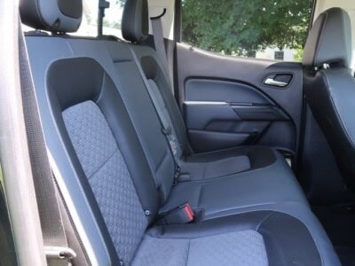 Interior view of 2018 Chevrolet Colorado Z71 showing rear seats and cabin features.