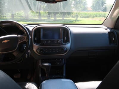 Interior view of a 2018 Chevrolet Colorado Z71 showing dashboard and steering wheel.
