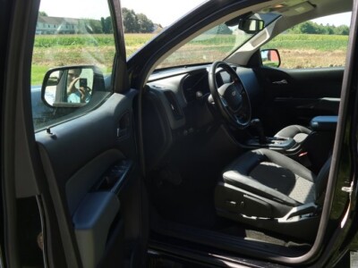 Interior view of a 2018 Chevrolet Colorado Z71 showing the dashboard and steering wheel.