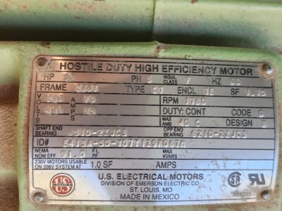 High efficiency industrial motor with label showing specifications and serial number.