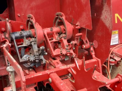 Close-up of New Holland 565 tractor's red hydraulic system and controls.