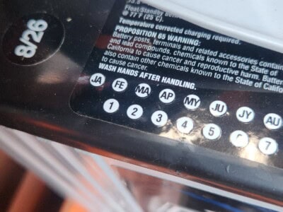 Close-up of battery label showing specifications and warnings.