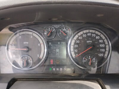 Vehicle dashboard showing RPM, speed, fuel, and engine temperature gauges.