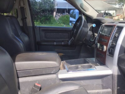 Interior view of a black pickup truck with leather seats and dashboard features.