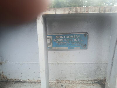 Montgomery Industries International metal identification plate on equipment.