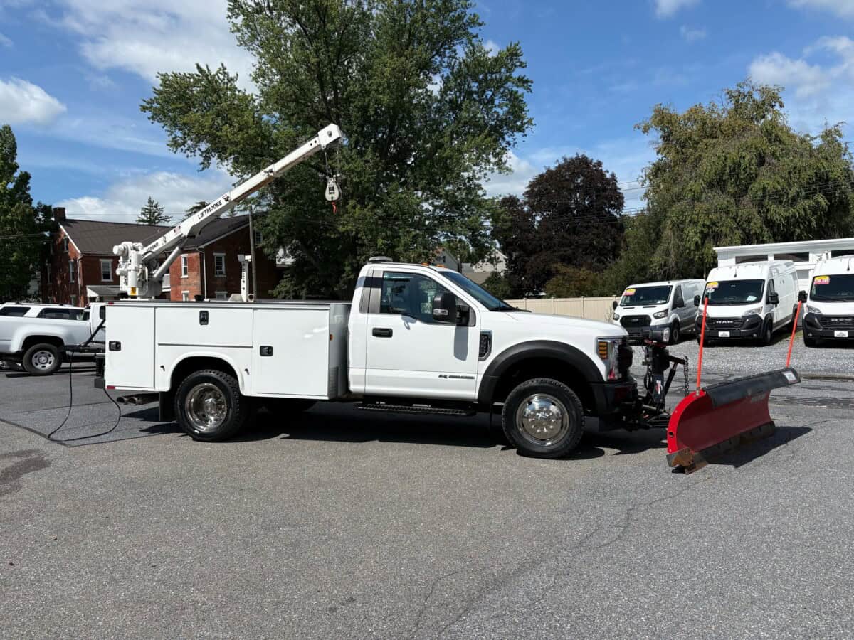 2018 Ford F-550 Super Duty XL utility truck with snow plow and bucket lift.