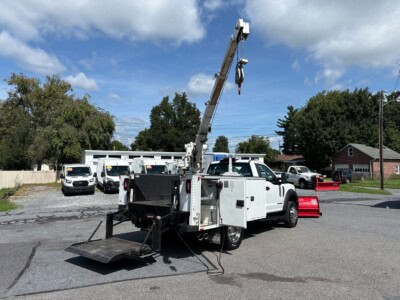 2018 Ford F-550 Super Duty utility truck with crane and equipment storage.