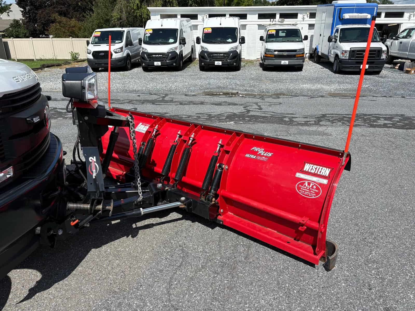 10946 - 2018 Ford F-550 Chassis - 014 Red Western snow plow attachment for trucks, with hydraulic lift and adjustable blades.