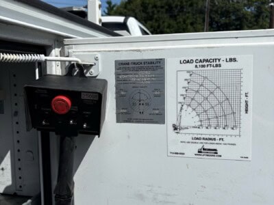 Load capacity and stability label on a truck equipment with crane details.