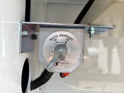 Master Disconnect switch mounted inside equipment enclosure with wiring and mounting bracket.