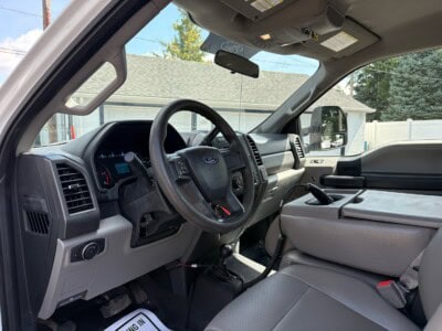 Interior view of a 2018 Ford F-550 Super Duty XL truck cab with steering wheel and dashboard.