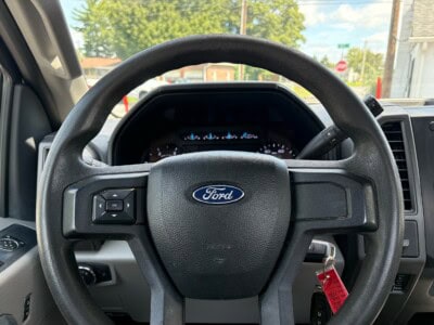 Ford F-550 Super Duty XL dashboard and steering wheel with key in ignition.
