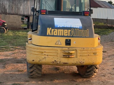 2000 Kramer-Allrad 520 compact loader with enclosed cab and yellow body.