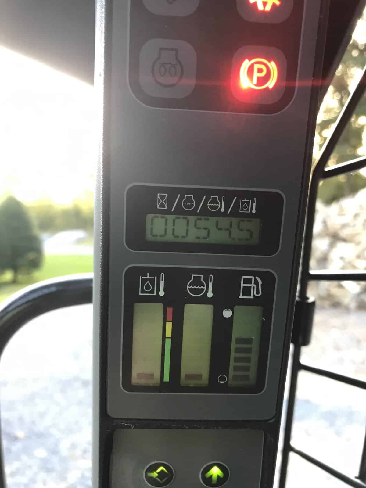 IMG_0746 (2) Close-up of tractor dashboard showing hour meter, fuel, oil, and hydraulic indicators.