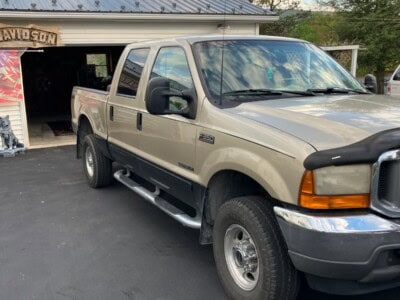 2008 Ford F-250 Super Duty pickup truck with extended cab and dual rear wheels.