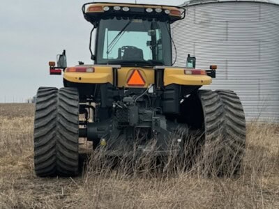 2013 Challenger MT855C tractor with large tires and enclosed cab on a farm.