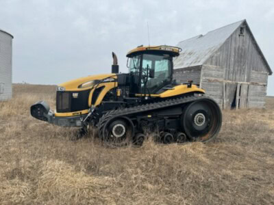 2013 Challenger MT855C tracked tractor with cab and tracks on a farm field.