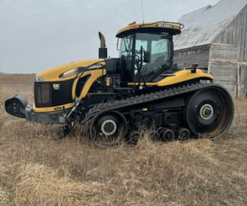 2013 Challenger MT855C tracked tractor with cab and rubber tracks on a farm field.